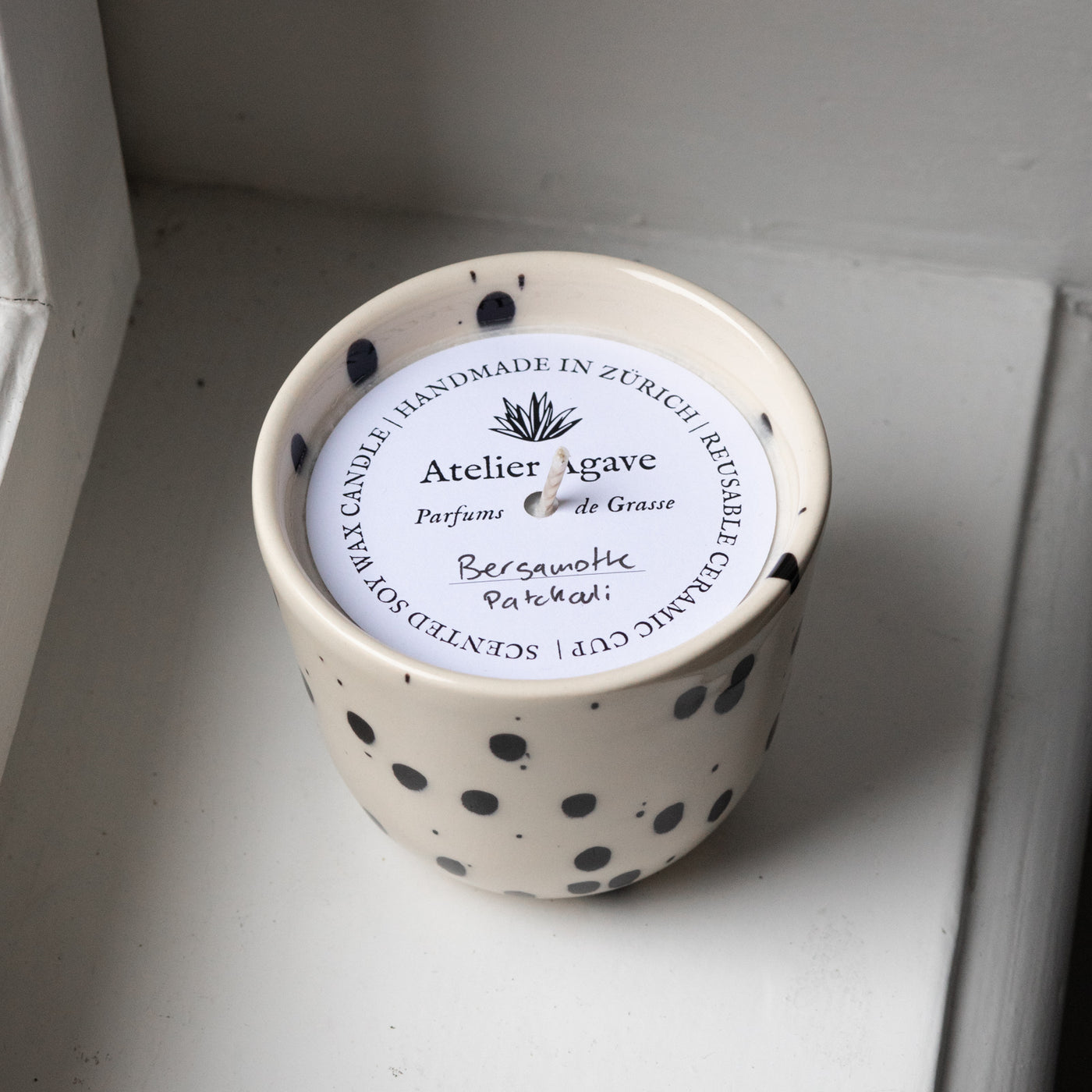 Scented candle bergamot patchouli in a cappuccino cup