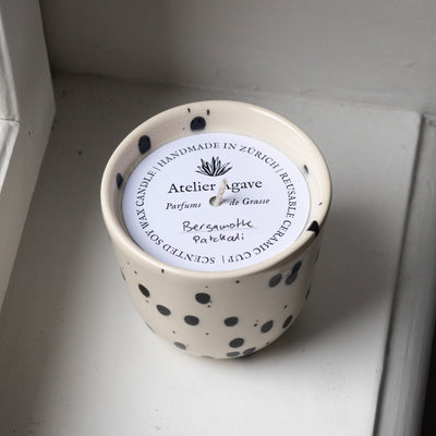 Scented candle bergamot patchouli in a cappuccino cup