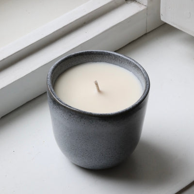 Wood scented candle in a cappuccino cup