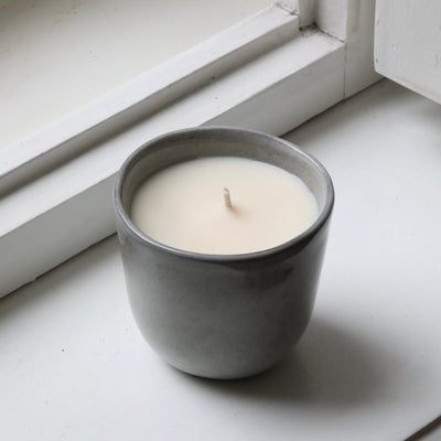 Wood scented candle in a cappuccino cup