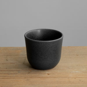 Matt black cappuccino mug on a wooden table