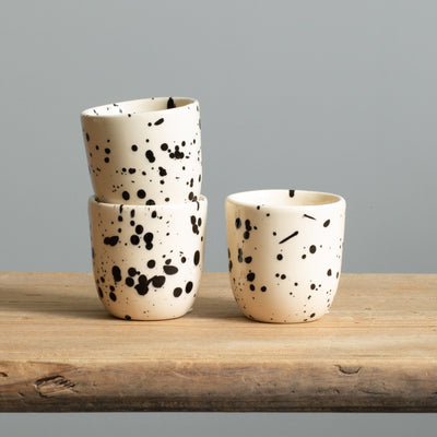 Stacked black dotted espresso mug in beige