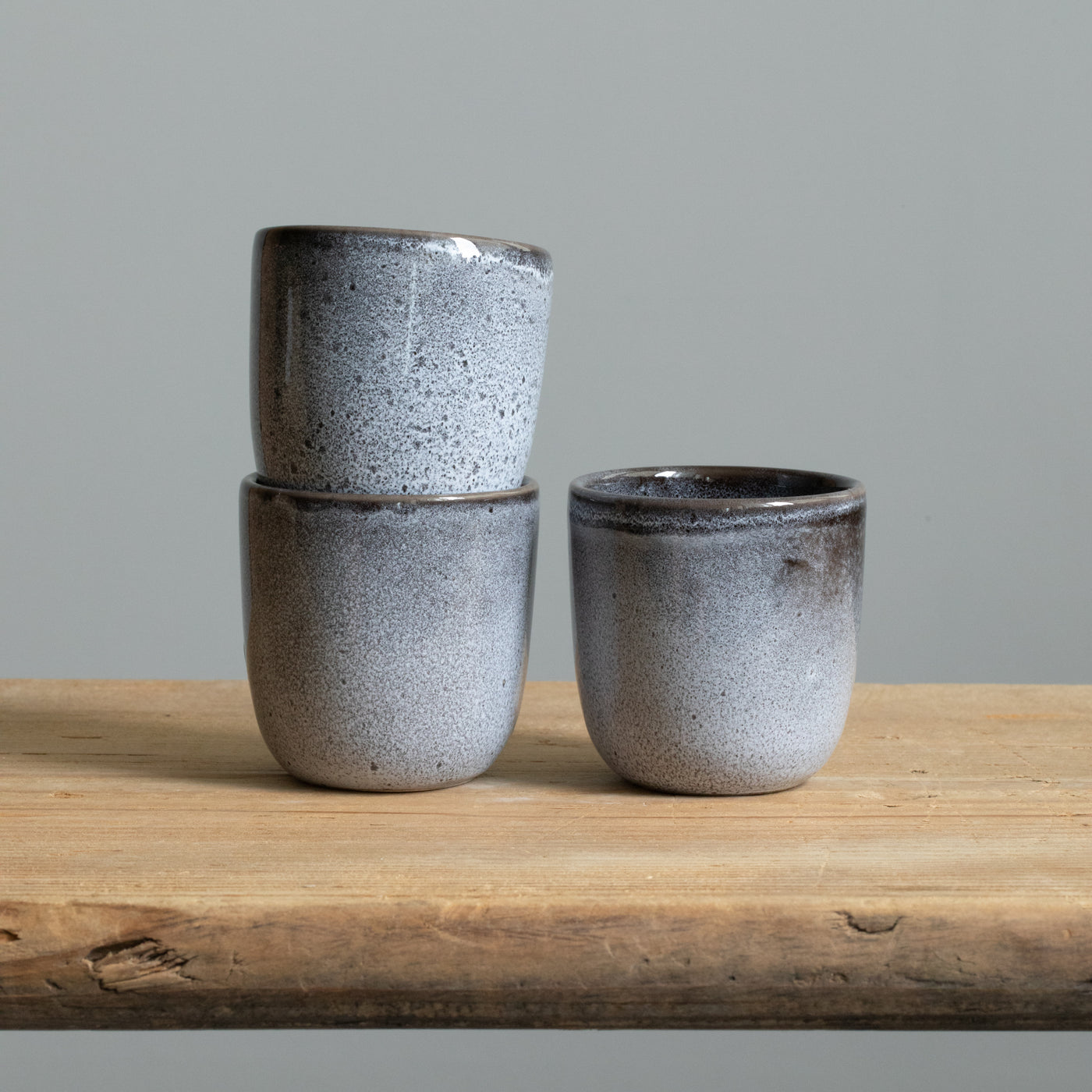 Three blue mottled espresso cups with reactive glaze