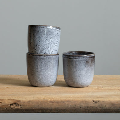 Three blue mottled espresso cups with reactive glaze