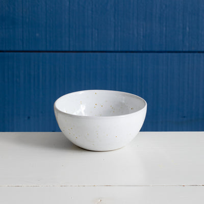 Stoneware dip bowl with white glaze and golden spots