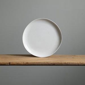 Large main course plate in white color with fine golden color splashes standing in front view