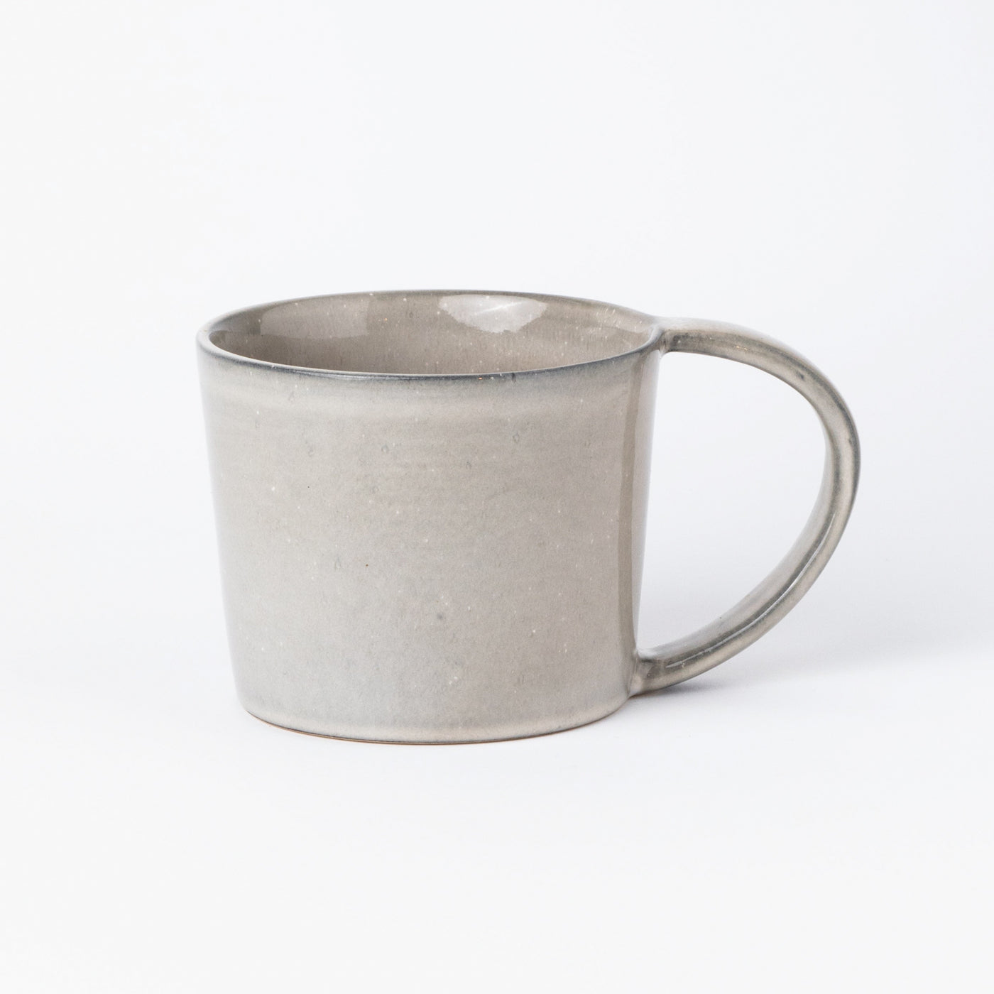 Grosse Teetasse mit Henkel in hellem grau und einem grossen Henkel in Frontansicht vor weissem Hintergrund
