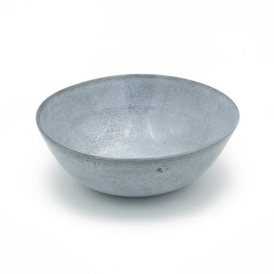 Blue salad bowl cropped against a white background