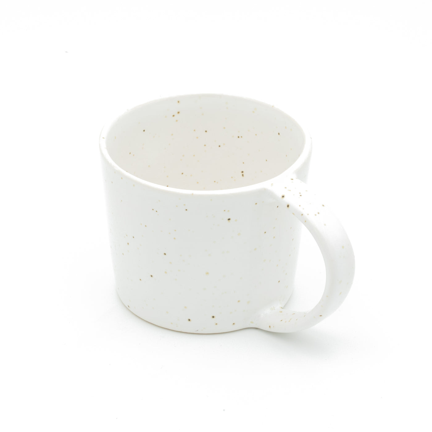 Large white teacup with fine golden speckles and a large handle for the whole hand on a white background