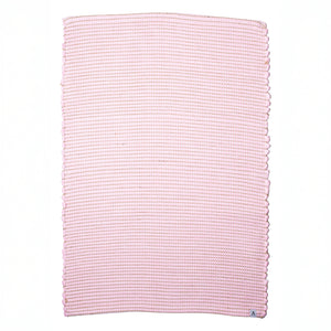 Small jute-striped rug in pink made from wool remnants hand-woven in Portugal against a white background