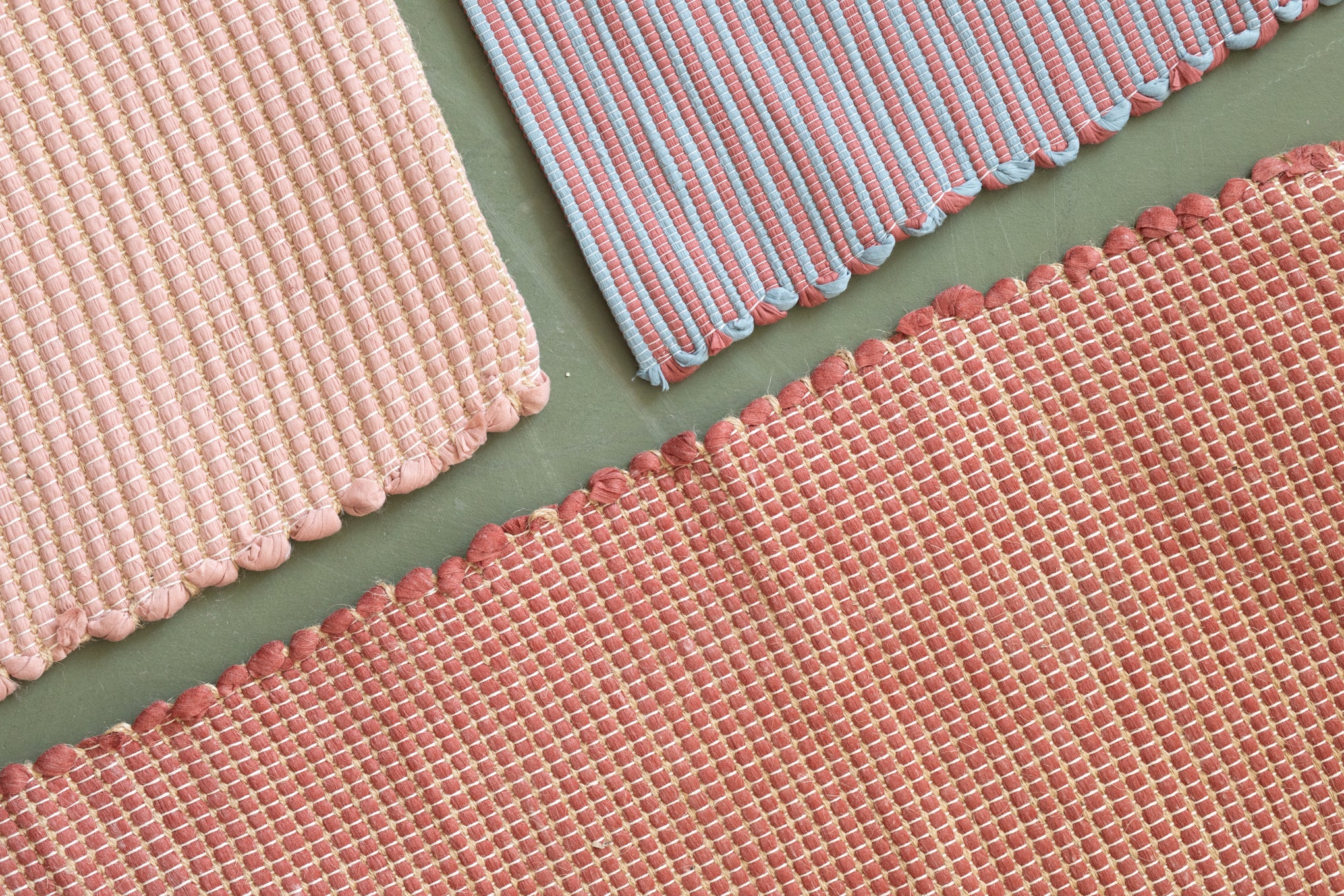 Close-up of three different carpets made from recycled cotton scraps in different colors
